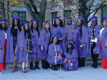 group of adults in caps and gowns